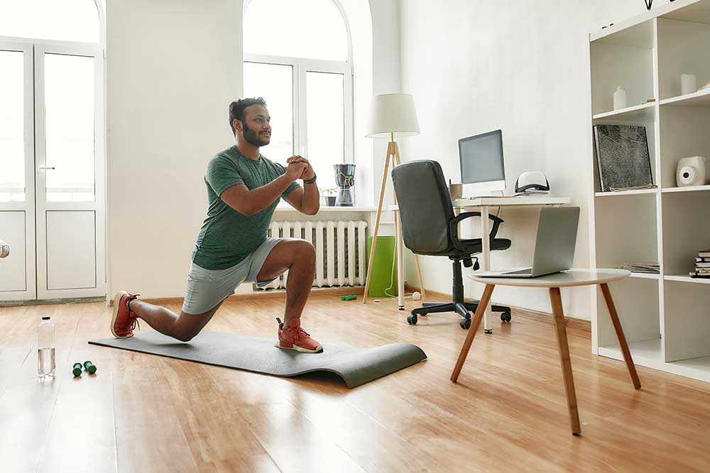 Person at home following a workout on their laptop.