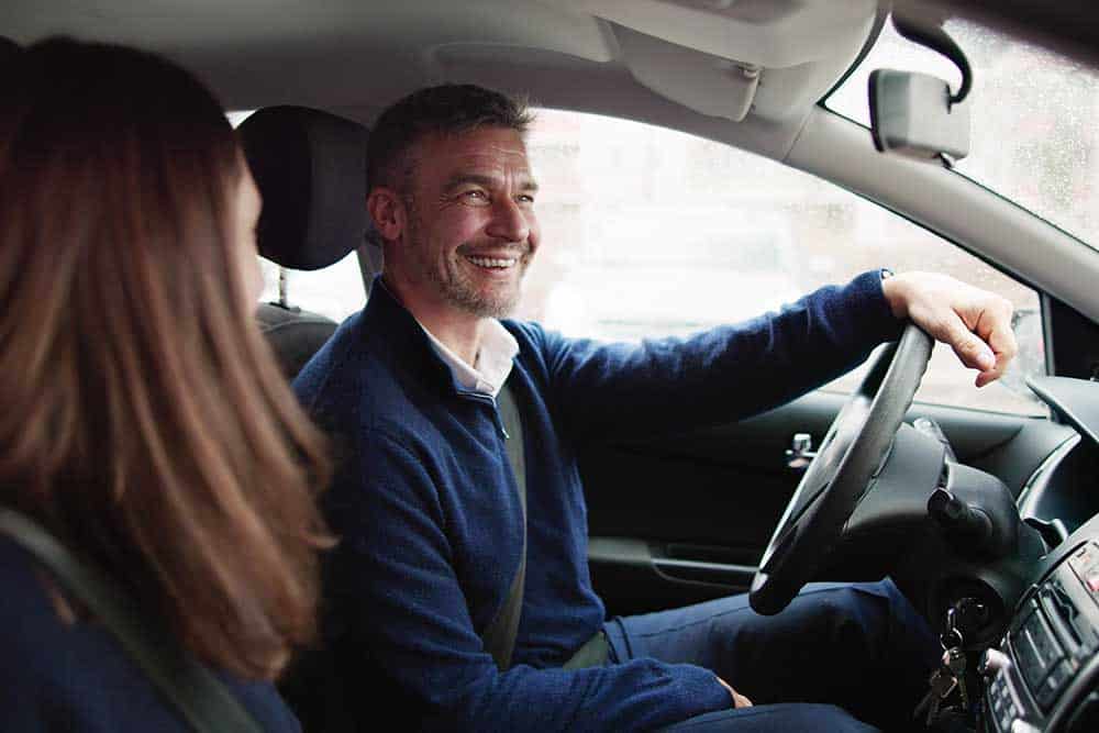 Colleagues sharing a ride to work via car-pooling.